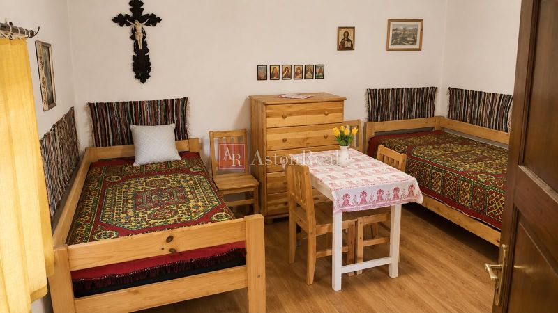 Rustic room in a cottage with patterned beds and wooden furniture.
