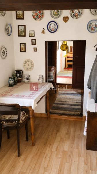 Traditional cottage interior with rustic decor, wooden patterned flooring.