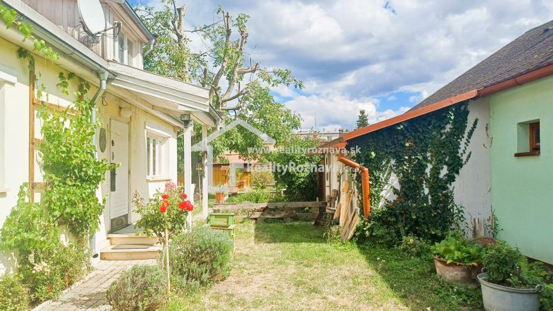 A family house in Rožňava with a garden and blooming roses in the yard.