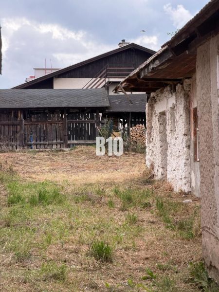 In Mošovce, a garden and buildings near a family house can be seen.