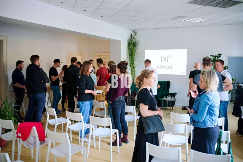People discussing in an office with empty chairs and a presentation.