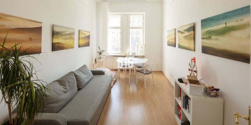 Cozy offices with a sofa, desk, and wood-decorated flooring.