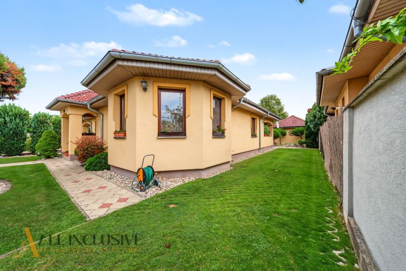 A family house on Kvetná Street in Veľké Dvorníky with a garden and a narrow walkway.