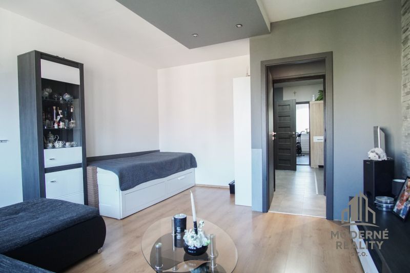 Living room in a 3-room apartment with a wooden decor floor and modern decoration.