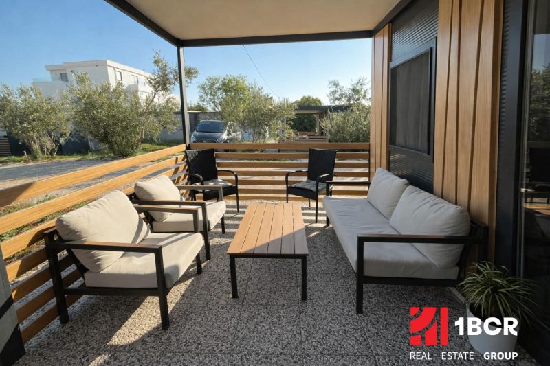 Terrace of a recreational apartment in Sukošan with comfortable furniture and greenery.