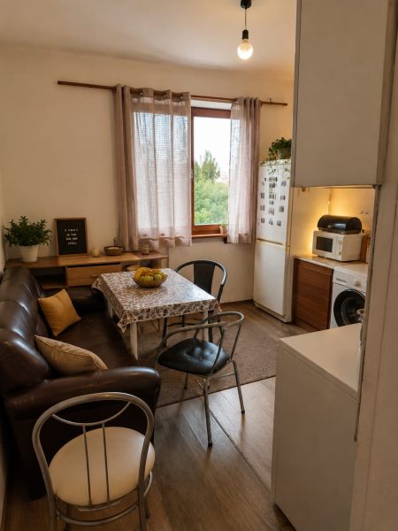 Interior of a 3-room apartment with a leather couch and a wood-patterned floor.