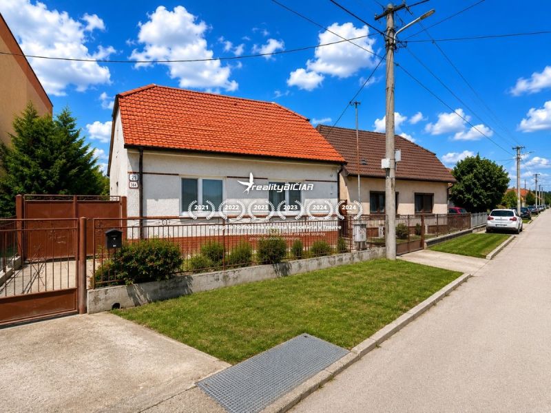 A family house on Orechova Street in Brestovany with a red roof and green lawn.