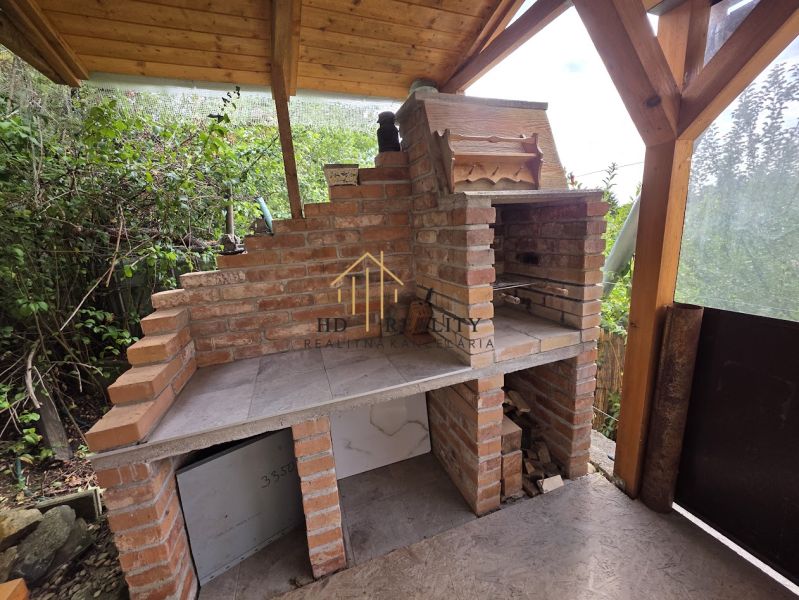 Baking in a cottage with a brick oven and a wooden roof in the garden.