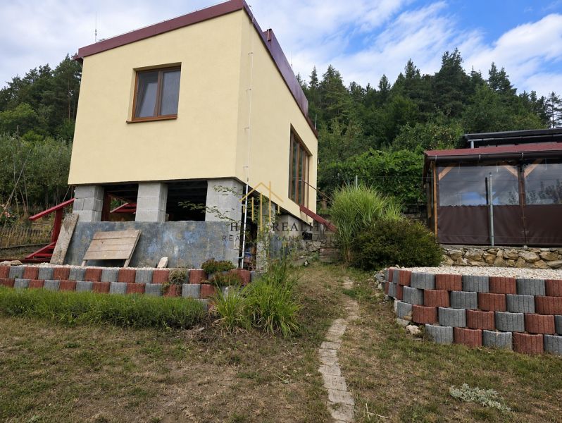 Cottage on Tulská in Banská Bystrica with a terrace, garden, and bordering the forest.