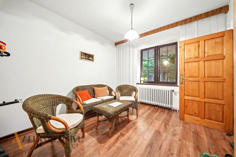 Cozy interior of a family house with wicker furniture and a wooden decor floor.