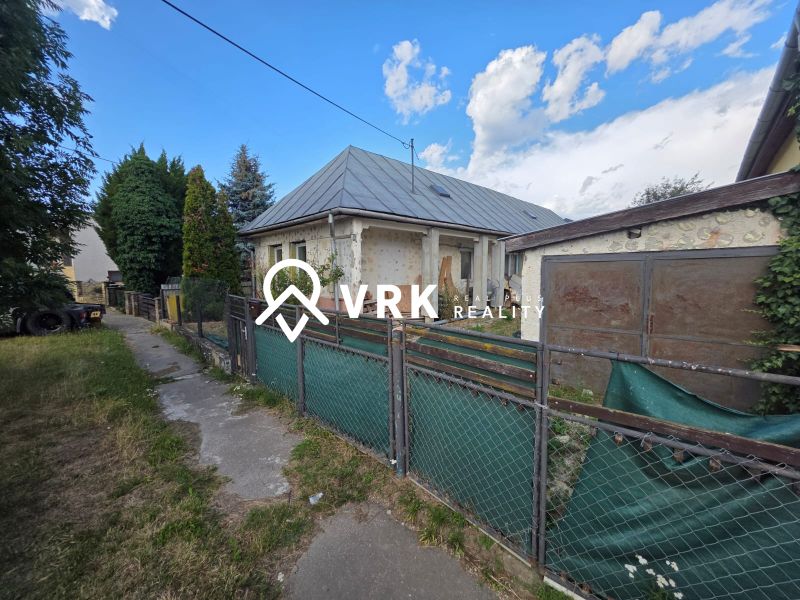 A family house in Kokšov - Bakša with a metal roof and a fenced garden.