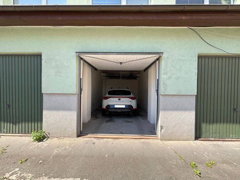 A car parked in a garage between buildings in Kežmarok.