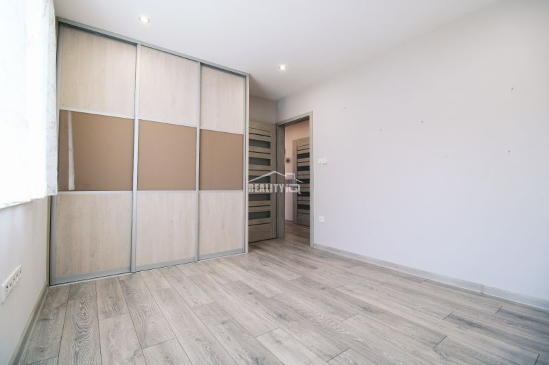 Interior of a family house with a wooden decor floor and a built-in wardrobe.