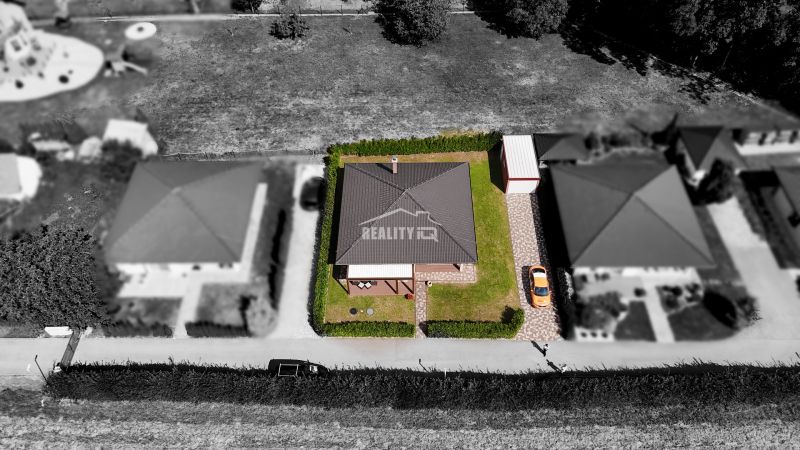 Aerial view of a family house in the town of Bytča with surrounding garden and driveway.