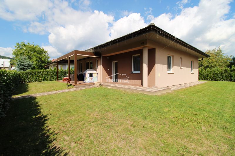 A family house in Bytča with a terrace surrounded by a green garden.
