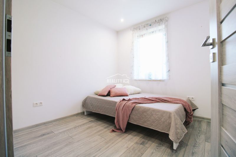 Children's room with a bed and a wooden decor floor in a family house.
