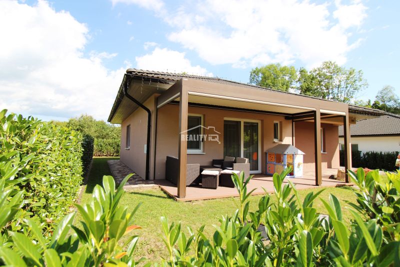 A family house in Bytča with a garden, terrace, and covered seating area in a sunny environment.