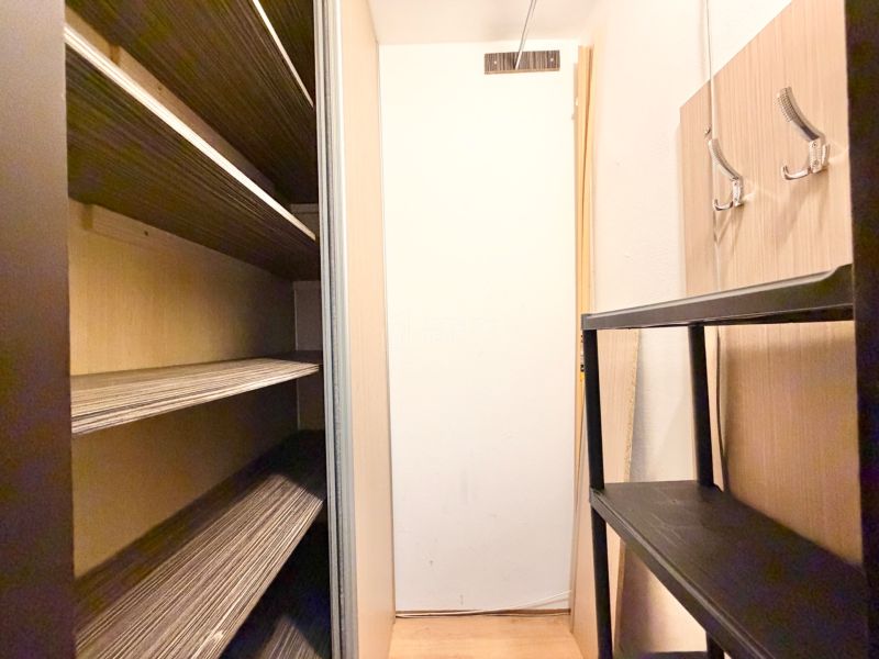 Storage space with shelves and hooks in a 2-room apartment.