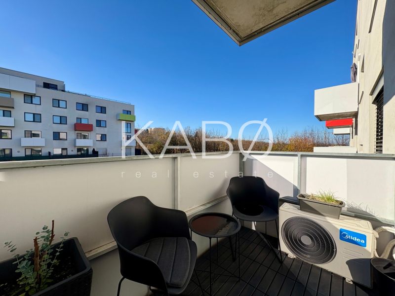 The balcony of a 2-room apartment on Hornostavska Street in Nitra, with modern seating and greenery.