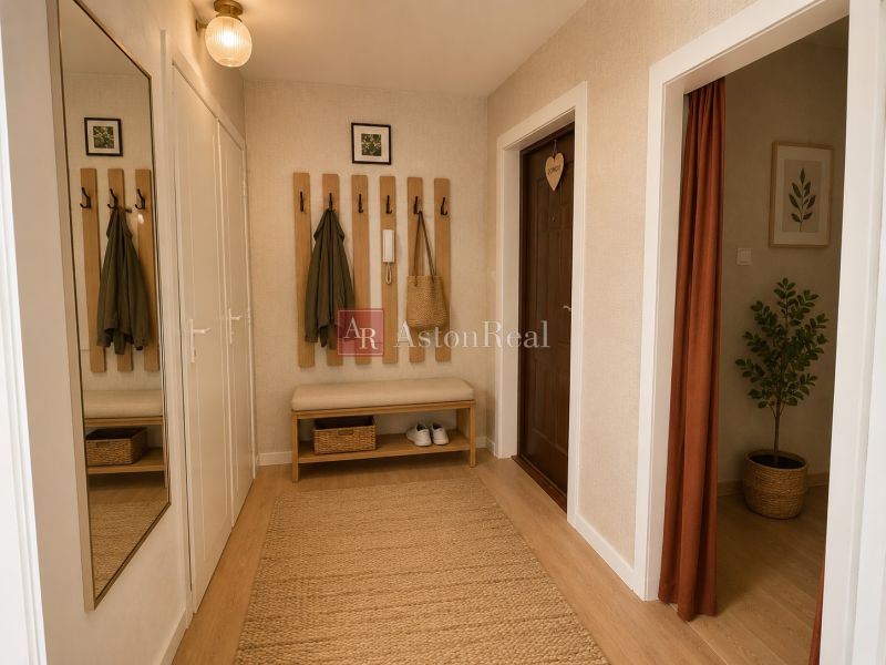 A hallway in a 2-room apartment with coat racks, a bench, a mirror, and a floor with a wooden decor.
