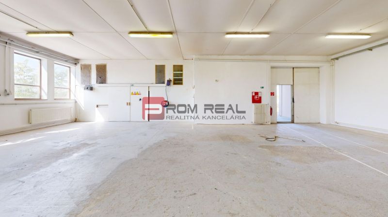 Bright production spaces with large windows and white walls.