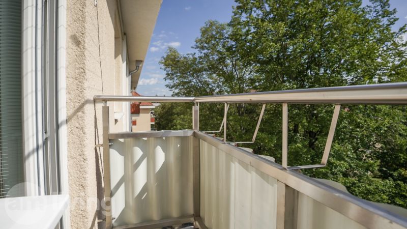 Rooftop terrace with metal railing and a view of the trees in Nova Dubnica.