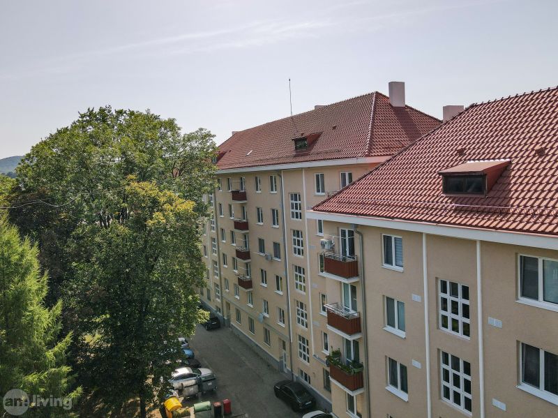 An apartment building on Sad kpt. Nálepku in Nová Dubnica surrounded by trees.