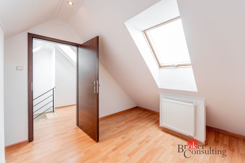 Attic room with a skylight, floor with wood decor, 3-room apartment.