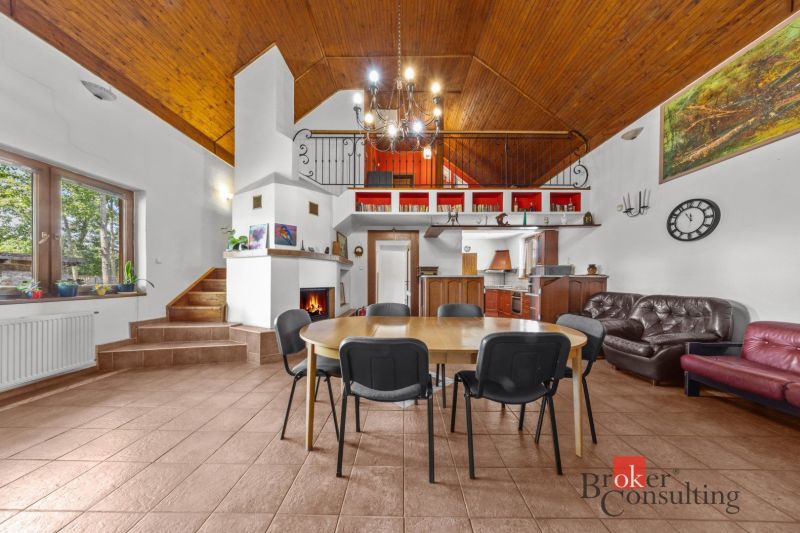 A family house with a large kitchen, a fireplace, and a wooden ceiling, with accessories that create a cozy atmosphere.