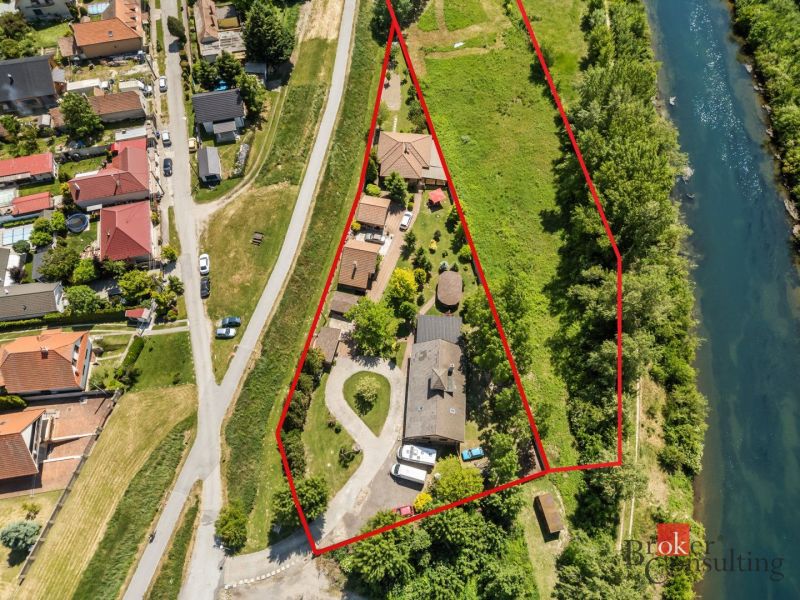 Aerial view of a family house in Hamuliakovo by the river with the plot marked.