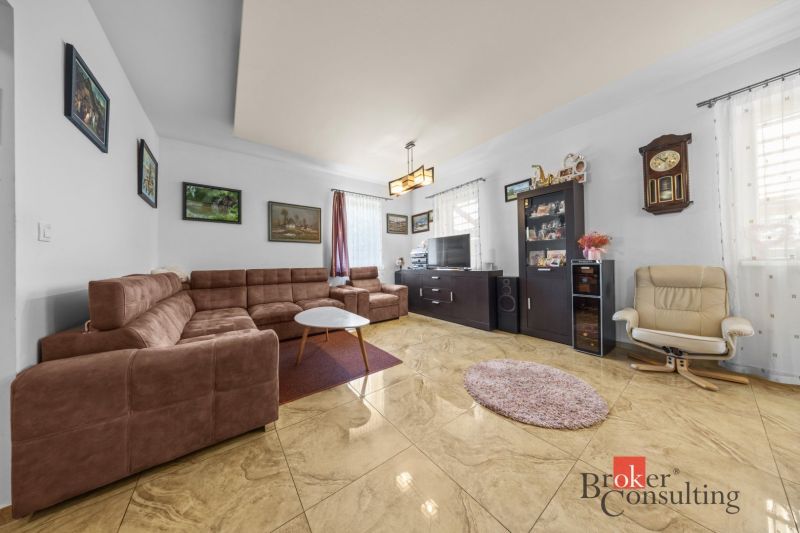 Living room in a family house with a comfortable sofa and paintings on the walls.