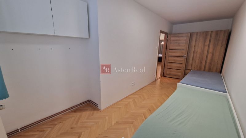 Children's room with two beds in a 3-room apartment, floor with wood decor.