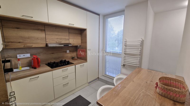 A kitchen in a 3-room apartment with a wooden decor floor and light cabinets.