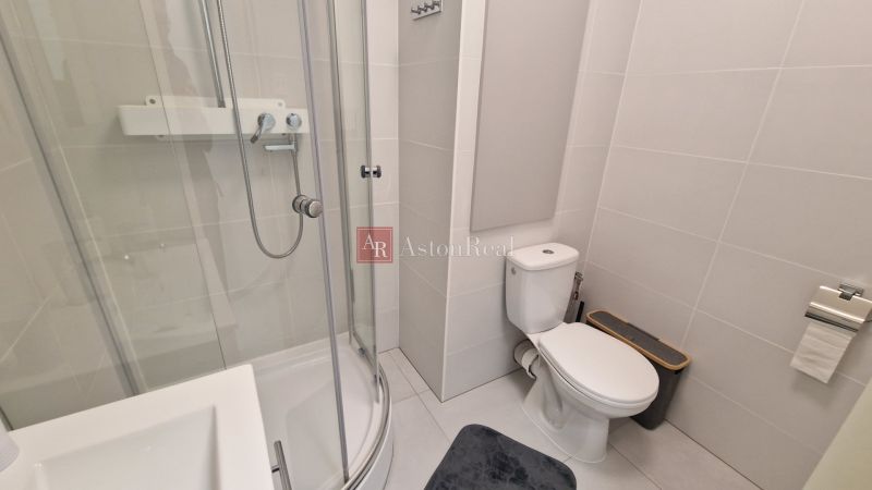Bathroom with shower and toilet in a 3-room apartment.