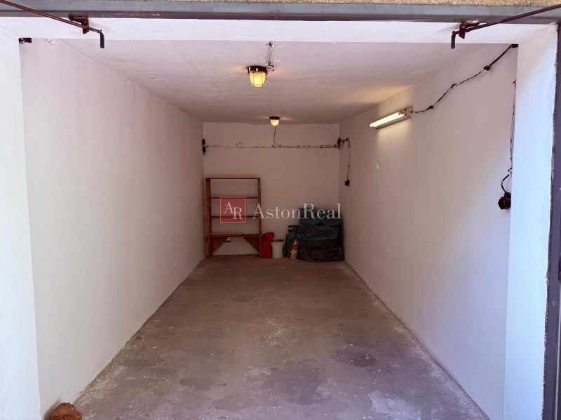 Simply furnished garages on Partizánska Street in Trenčín with shelving and lighting.