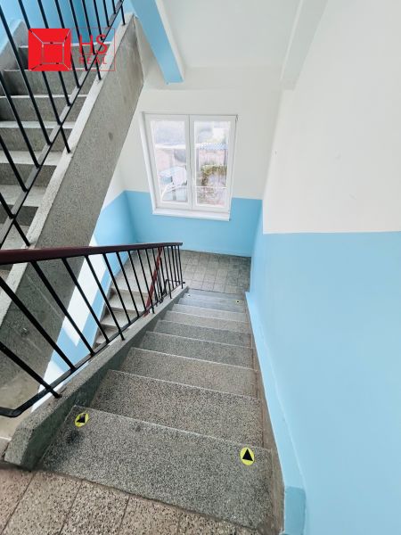 The staircase of the apartment building with a blue wall and railing on Petőfi Street, Nové Zámky.