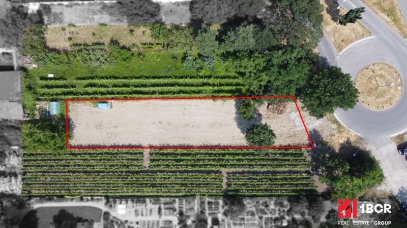 A plot for residential use in Pezinok on Holubyho Street surrounded by greenery and a road.