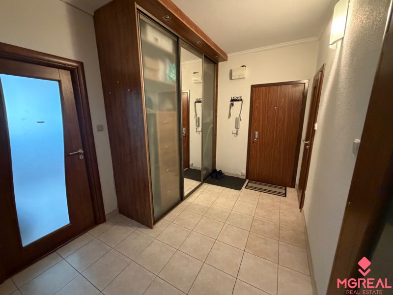 The entrance hallway of a 3-room apartment with tiles and a wardrobe.