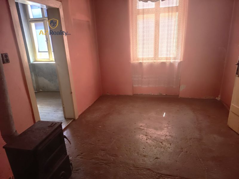 A room with old furniture and pink walls in a family house.