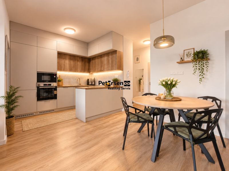 A kitchen with built-in appliances and a dining table in a 4-room apartment, with a wooden decor floor.