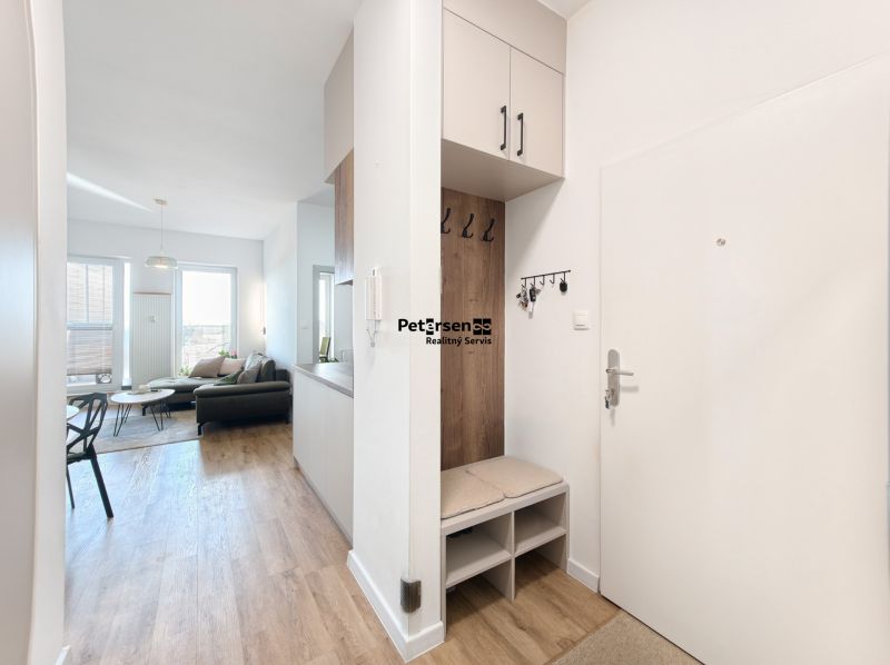 Interior of a 4-room apartment with a wooden decor floor and comfortable seating.