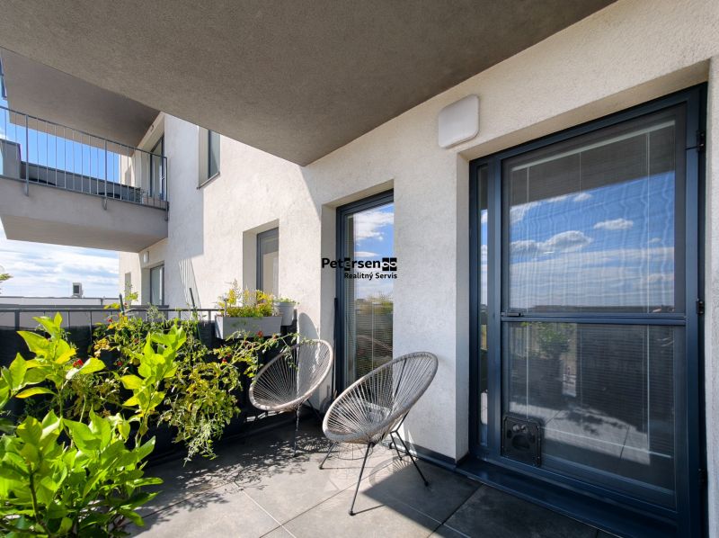 Balcony of a 4-room apartment on Zelená stráň, Košice, with plants and seating.