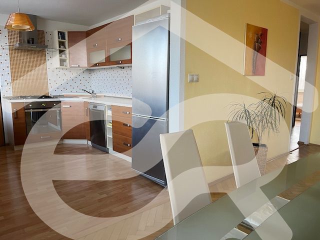 A kitchen with a wood-patterned floor in a 3-room apartment, modern furniture and decorations.