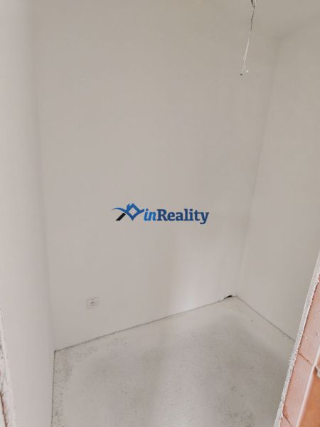 Pantry in a 3-room apartment with white walls and a socket on the wall.