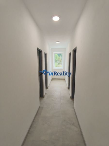 A hallway in a 3-room apartment with smooth walls and a light floor.