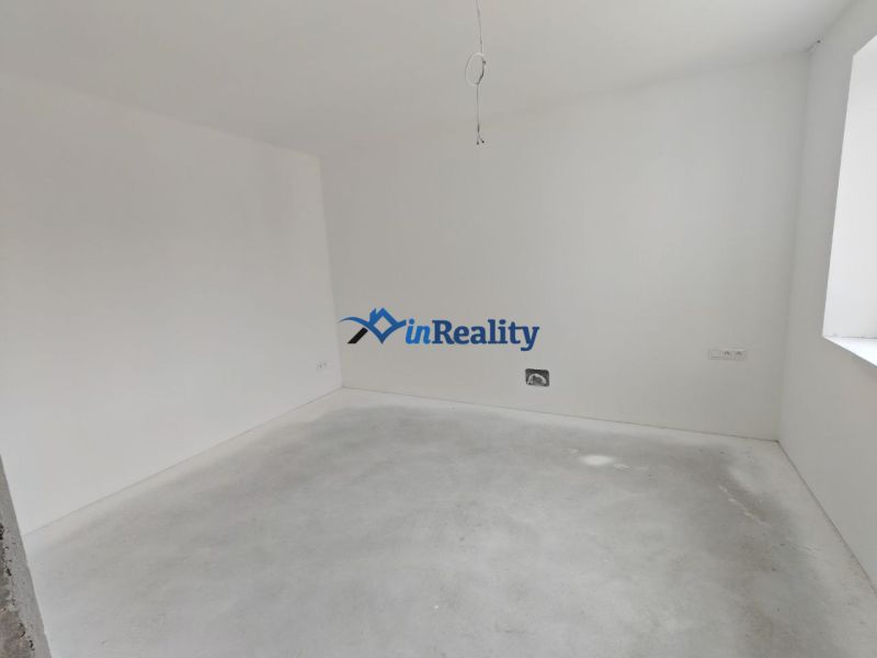 An empty room in a 3-room apartment with walls ready for painting.