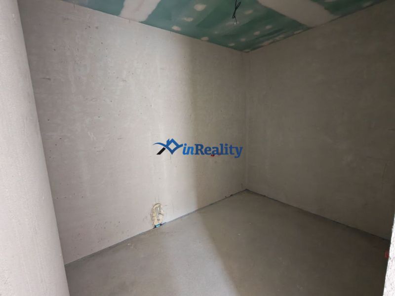 Bare walls and a concrete floor in a newly built 3-room apartment awaiting completion.
