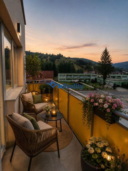 The balcony of a 2-room apartment on Školská Street in Hriňová with a view of nature at sunset.