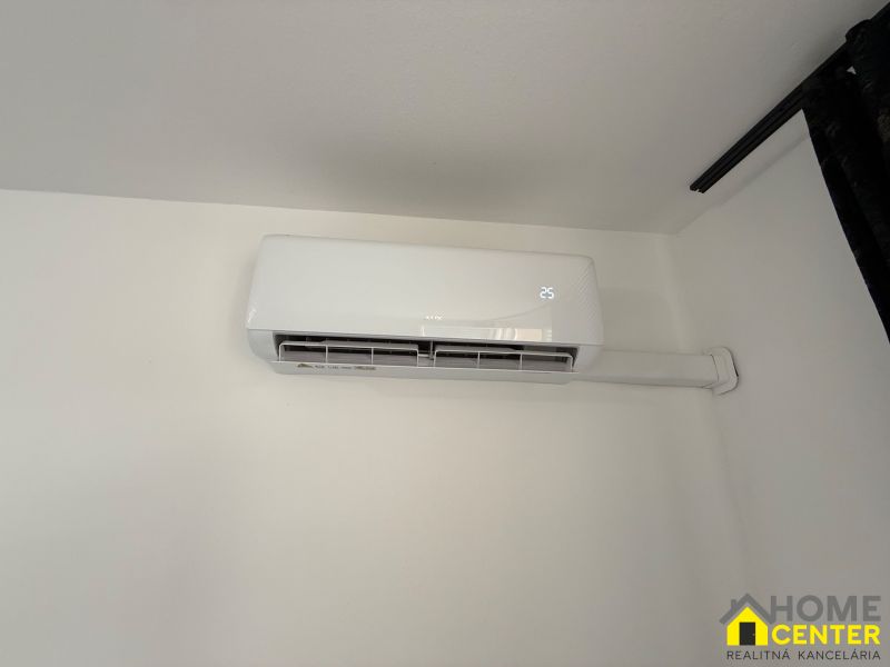 Air conditioning installed in a 3-room apartment, temperature display on the screen.