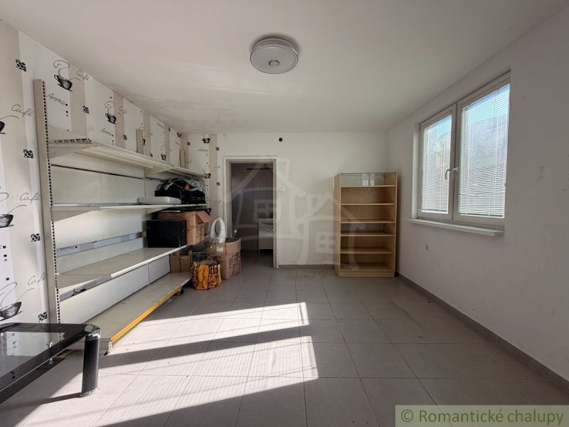 The interior of a family house with shelving units and boxes on the floor.